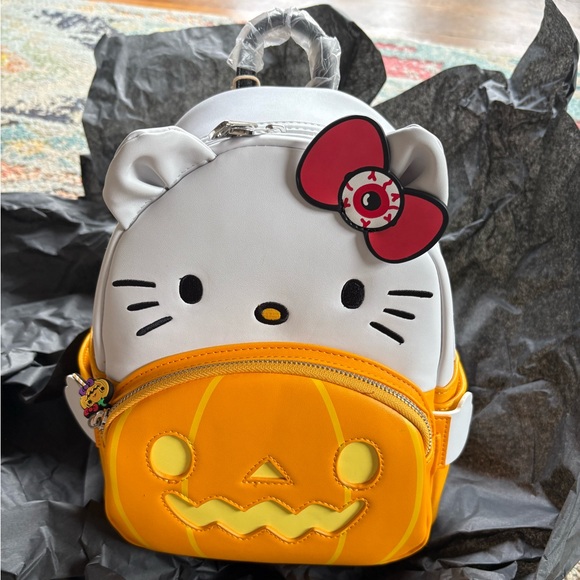 hello kitty loungefly halloween backpack Sanrio Spooky ShopHippo Vegan leather (polyurethane) Adjustable shoulder straps Zippered front pocket Side drop pockets Rose gold hardware Detachable vegan leather bag charm with printed character art Applique Loungefly Sanrio Hello Kitty Spooky